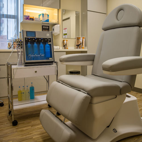 Gray treatment chair at Patricia Yuen Skin Clinic in Singapore with cosmetic equipment